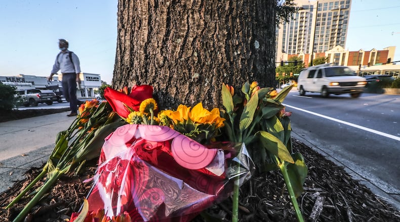 October 13, 2021 Atlanta: A memorial of flowers is growing outside Havertys Furniture located at 3255 Peachtree Road in Buckhead on Wednesday, Oct. 13, 2021 after a woman died within hours of tumbling out of a moving car in Buckhead late Sunday, and police are working to determine if she was pushed from it. The woman was found unconscious on the pavement in the intersection of Piedmont and Peachtree roads about 11 p.m., Atlanta police said in a statement. She was rushed to a hospital but died of her injuries. “Preliminary investigation indicated that the victim may have been pushed or may have fallen from a moving vehicle,” the statement said. Police said the car sped away from the scene, leaving her behind. It has not been located. While officers were initially called to the scene on a report of a person being hit by a car, it is not clear if such a crash resulted in the woman’s death. An investigation is ongoing. (John Spink / John.Spink@ajc.com)