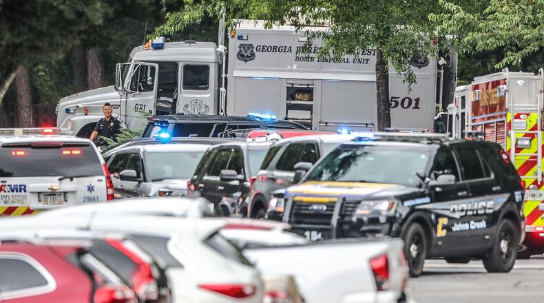 Authorities block Old Alabama Road in Johns Creek as a suspicious package left near a women's health clinic is investigated.