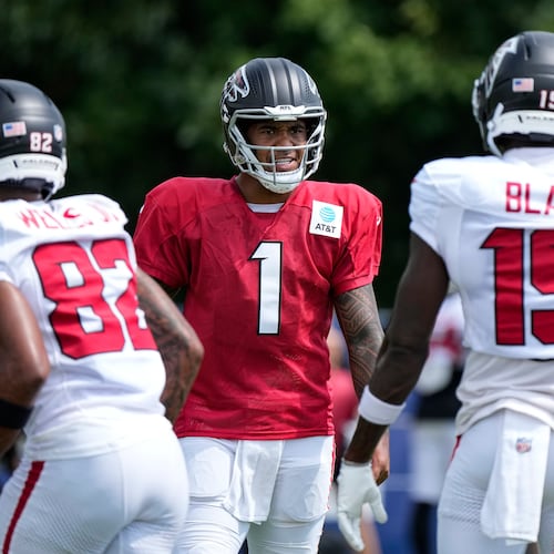 Atlanta Falcons quarterback Tua Tagovailoa (1) cuts between wide receiver Antwane Wells Jr. (82) and wide receiver Chris Blair (19) during a joint practice with the Indianapolis Colts at the team's NFL football training camp in Westfield, Ind., Wednesday, Aug. 19, 2026. (AP Photo/Michael Conroy)