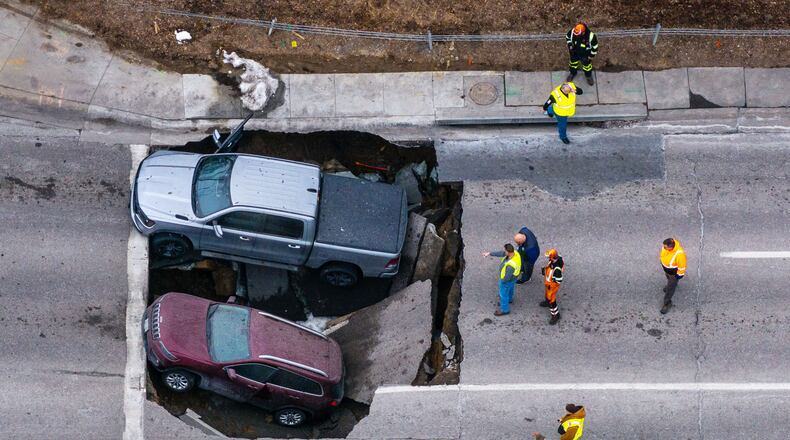 FILE - Authorities assess two vehicles that fell into a sinkhole in Omaha on Feb. 24, 2026. (Chris Machian/Omaha World-Herald via AP, File)