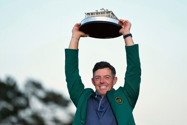 Winner Rory McIlroy holds the trophy at the Masters Sunday.