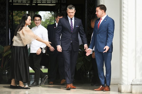 U.S. Defense Secretary Pete Hegseth, center, arrives to meet with Philippine President Marcos Jr. at the Malacanang presidential palace in Manila, Philippines, Friday, March 28, 2025. (AP Photo/Basilio Sepe, Pool)