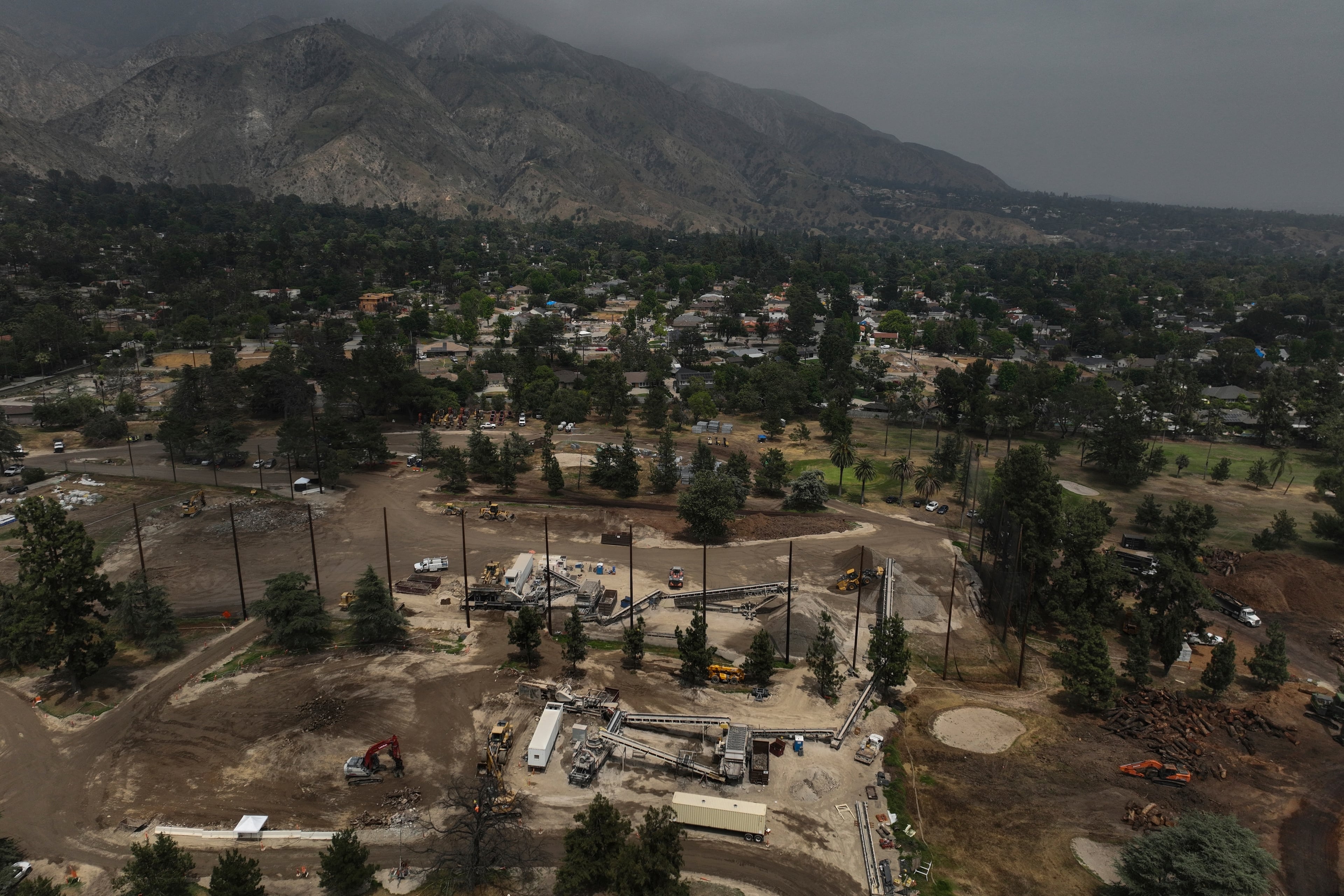 A recycling facility occupies a golf course in Altadena, Calif., Wednesday, June 4, 2025, where debris from wildfires is processed. (AP Photo/Jae C. Hong)