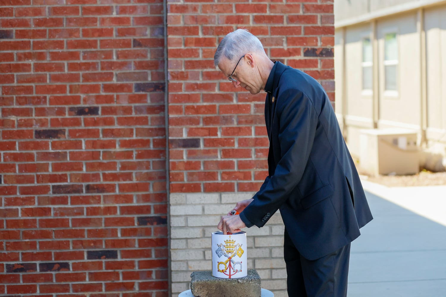 Father Matthew Kaderabek, who serves as the chaplain for students from Pre-Kindergarten to 8th grade, is observed burning the ballots after a new pope was chosen during a pretend papal election at Pinecrest Academy on Tuesday, May 6, 2025.
(Miguel Martinez/ AJC)
