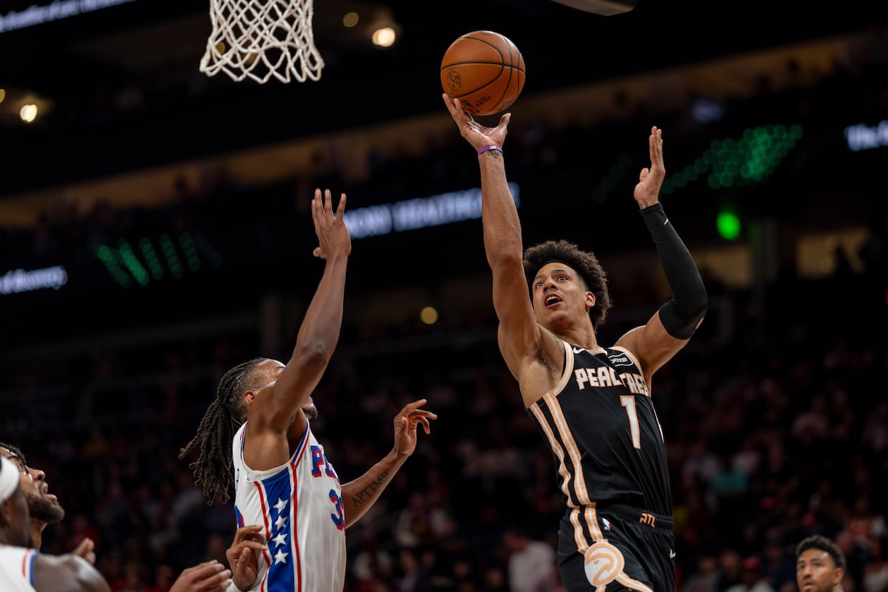 Atlanta Hawks forward Jalen Johnson (1) attempts a basket against Philadelphia 76ers forward Jabari Walker (33) during the first half of an NBA basketball game, Saturday, March 7, 2026, in Atlanta. (AP Photo/Erik Rank)