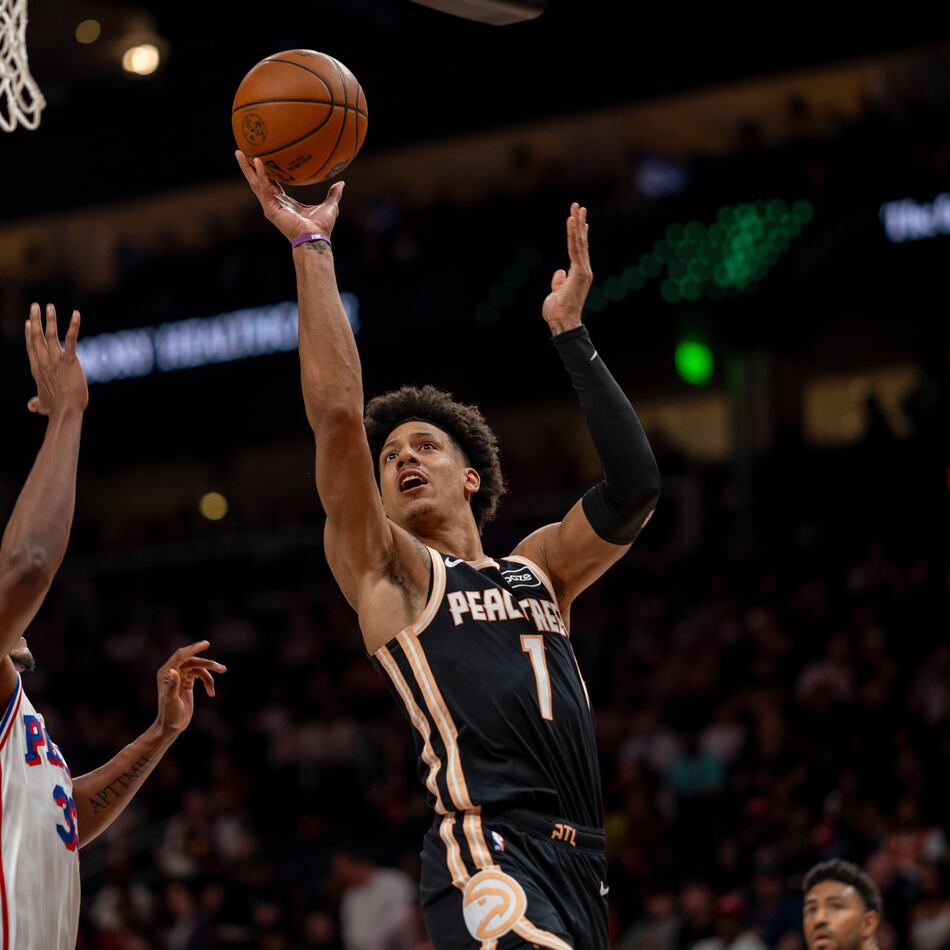 Atlanta Hawks forward Jalen Johnson (1) attempts a basket against Philadelphia 76ers forward Jabari Walker (33) during the first half of an NBA basketball game, Saturday, March 7, 2026, in Atlanta. (AP Photo/Erik Rank)