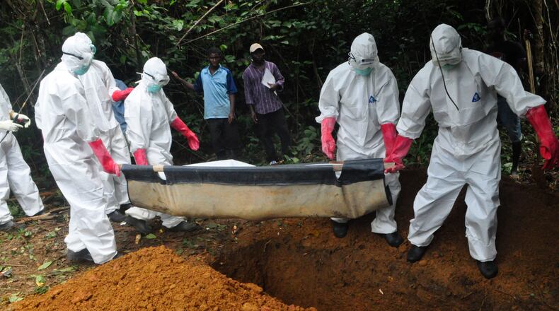 FILE : In this Saturday, Oct. 18, file photo a burial team in protective gear bury the body of a woman suspected to have died from Ebola virus in Monrovia, Liberia. The disease has ravaged a small part of Africa, but the international image of the whole continent is increasingly under siege, reinforcing some old stereotypes. (AP Photo/Abbas Dulleh, File) In this Saturday photo a burial team in protective gear bury the body of a woman suspected to have died from Ebola virus in Monrovia, Liberia. The disease has ravaged a small part of Africa, but the international image of the whole continent is increasingly under siege. AP /Abbas Dulleh
