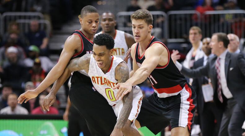 ATLANTA: Hawks guard Jeff Teague is fouled by Trial Blazers defenders Tim Frazier (left) and Meyers Leonard during a basketball game on Monday, Dec. 21, 2015, in Atlanta. The Hawks beat the Trail Blazers 106-97. Curtis Compton / ccompton@ajc.com