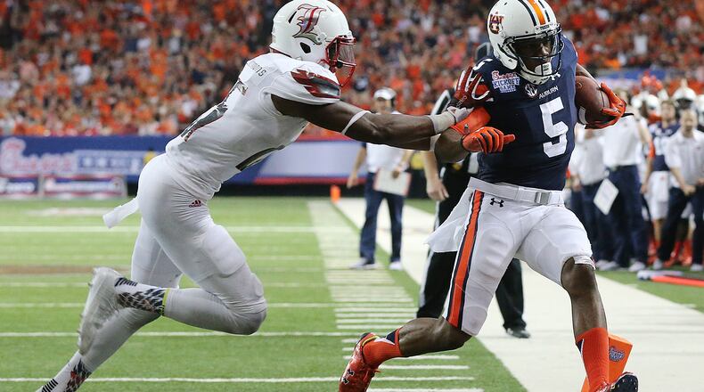 090515 ATLANTA: Auburn wide receiver Ricardo Louis gets in the endzone past Louisville safety Josh Harvey-Clemons for a 31-10 Auburn lead during the fourth quarter in the Chick-fil-A Kickoff Game on Saturday, Sept. 5, 2015, in Atlanta. Curtis Compton / ccompton@ajc.com