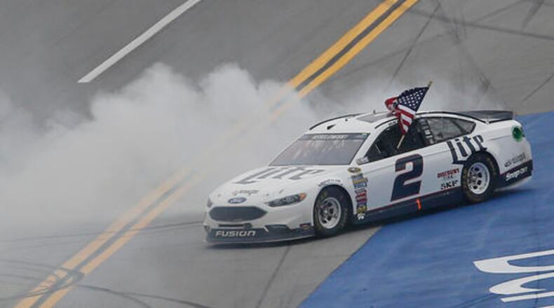 Brad Keselowski burns out and celebrates after winning during the NASCAR Talladega auto race at Talladega Superspeedway, Sunday, May 1, 2016, in Talladega, Ala. (AP Photo/John Bazemore)