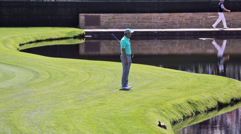 Sergio Garcia looks into the pond where he hit five balls into the water on 15 during the first round of the Masters at Augusta National Golf Club.