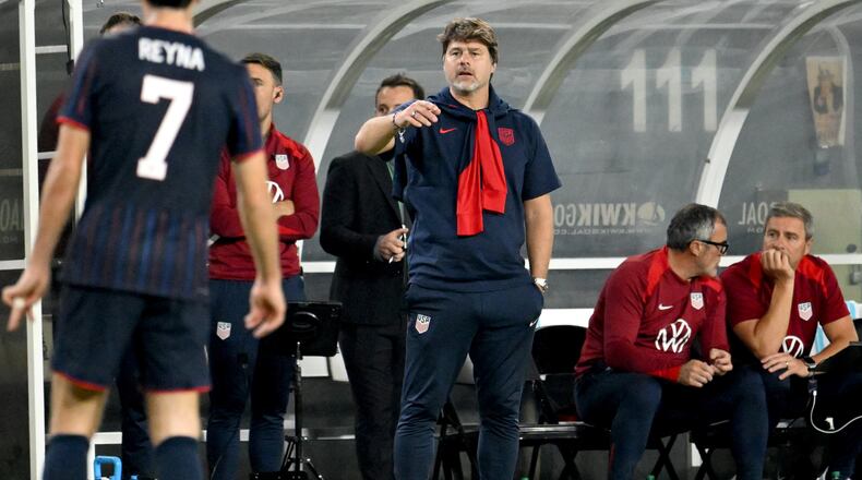 United States head coach Mauricio Pochettino (center) speaks to Gil Reyna during the second half of an international friendly soccer game against Uruguay on Tuesday, Nov. 18, 2025, in Tampa, Fla. (Jason Behnken/AP)