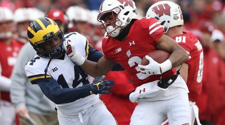 Michigan's Josh Meetellus tackles Wisconsin's Kendric Pryor during first quarter action on Saturday, Nov. 18, 2017 at Camp Randall Stadium in Madison, Wis. Wisconsin won, 24-10. (Kirthmon F. Dozier/Detroit Free Press/TNS)