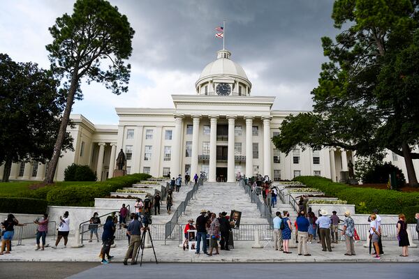 People wait in line to view the body of Congressman John Lewis in the Alabama Capitol Sunday, July 26, 2020, in Montgomery, Ala.  The congressman from Georgia and civil rights icon died July 17 at age 80 after a battle with pancreatic cancer. (AP Photo/Julie Bennett)