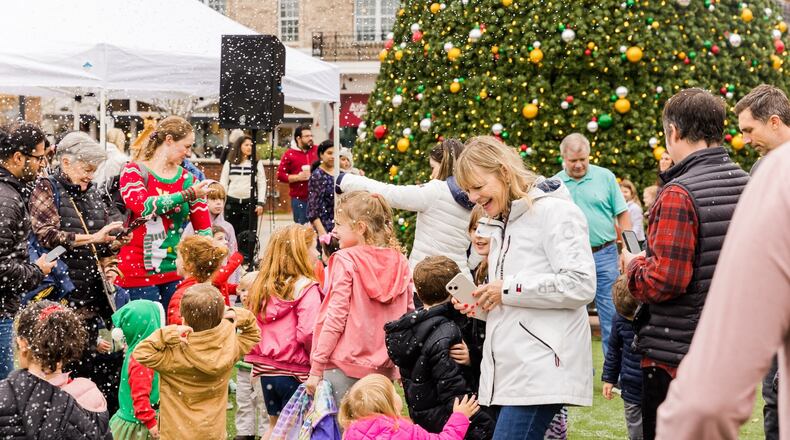 Play in a winter scene created by snow machines on Saturday in Alpharetta. (Courtesy of Alpharetta City Center)