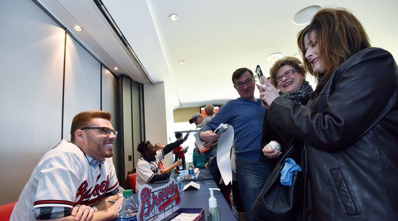 Braves slugger Freddie Freeman gets his picture taken by a fan at the 2016 FanFest at Turner Field.  After a one-year absence, the Braves have renamed the event Chop Fest and will have it Jan. 27-28 at SunTrust Park. (HYOSUB SHIN / HSHIN@AJC.COM)