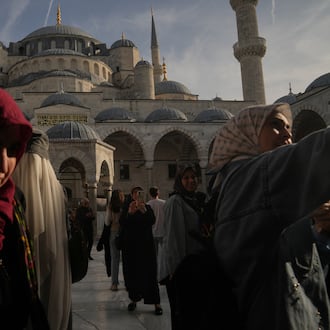Locals and tourists visit the Ottoman-era Sultan Ahmed or Blue Mosque, in Istanbul, Turkey, Friday, Nov. 21, 2025, ahead of the visit of Pope Leo XIV to Turkey. (AP Photo/Francisco Seco)