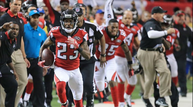 SUDDEN DEATH: The Falcons sideline reacts as Robert Alford intercepts Redskins quarterback Kirk Cousins in overtime and returns it for the game-winning touchdown and a final score of 25-19 in their football game on Sunday, Oct. 11, 2015, in Atlanta. The Falcons remain perfect at 5-0 with the victory. (Photo by Curtis Compton)