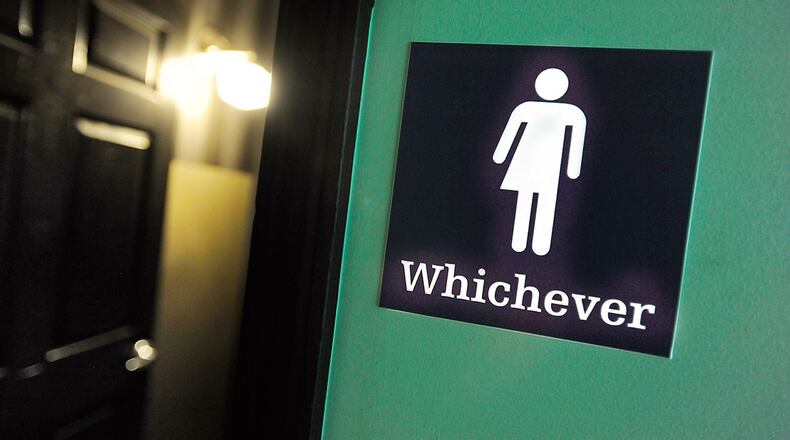 A gender neutral sign is posted outside a bathrooms in North Carolina. Debate over transgender bathroom access has spread nationwide. (Photo by Sara D. Davis/Getty Images)