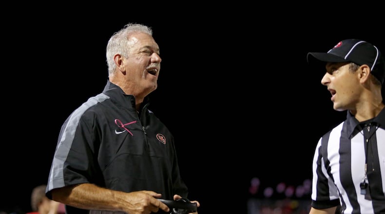North Gwinnett coach Bob Sphire, left, talks with an official during the first half of their game against Norcross Friday in Suwanee, Ga., October 3, 2014. JASON GETZ / SPECIAL