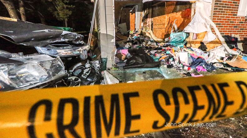 A car hit the garage and went through the back of a DeKalb County home following a deadly road rage shooting.