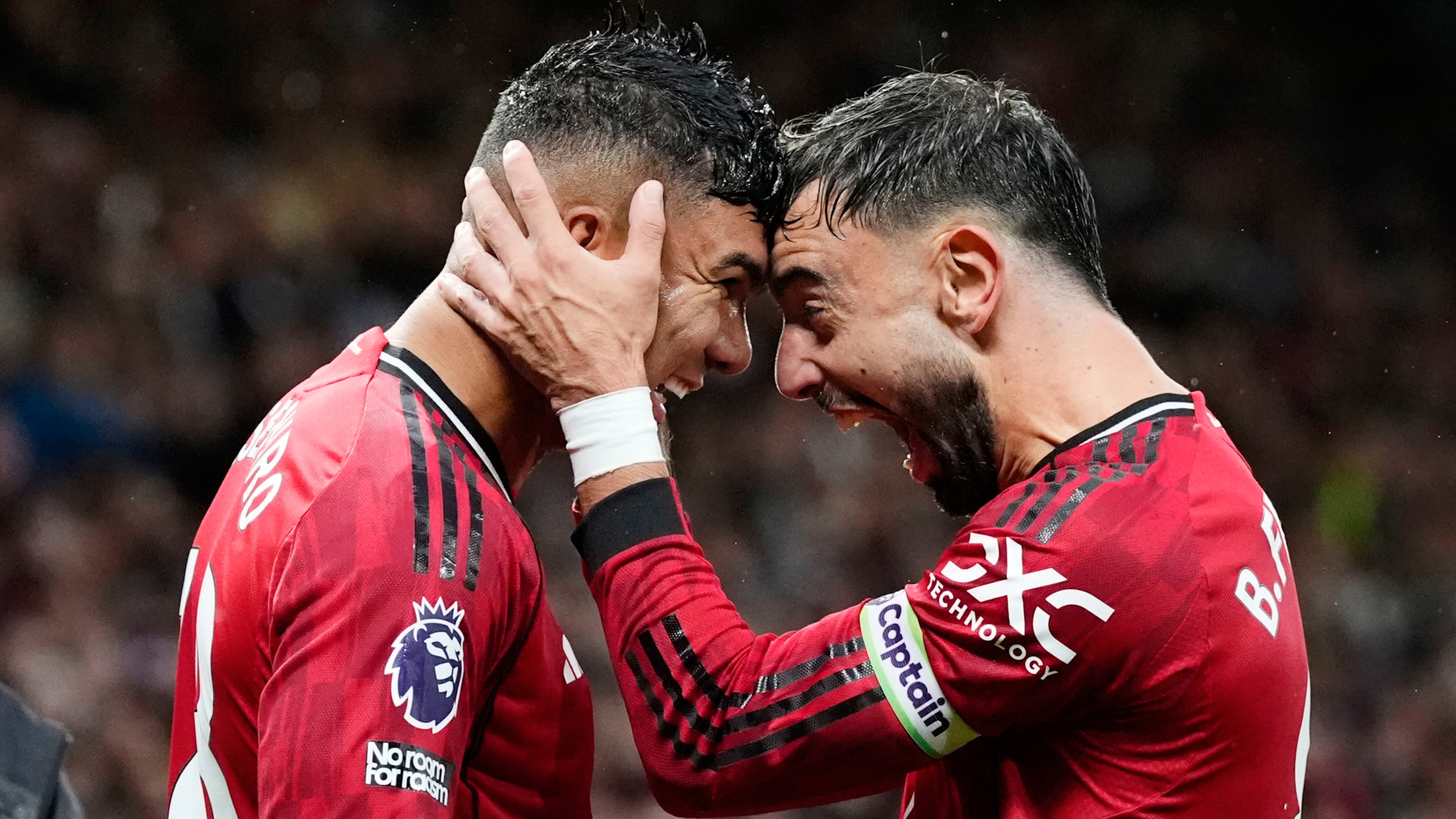 Manchester United's Casemiro, left, celebrates with Bruno Fernandes after scoring their second goal during the English Premier League soccer match between Manchester United and Chelsea at the Old Trafford stadium in Manchester, England, Saturday, Sept. 20, 2025. (Nick Potts/PA via AP)