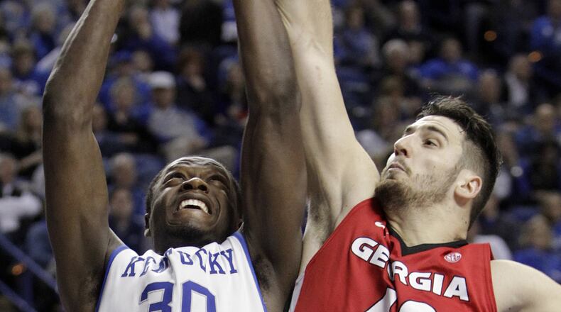 Kentucky's Julius Randle (30) shoots as Georgia's Nemanja Djurisic (42) defends during the second half of an NCAA college basketball game Jan. 25, 2014, in Lexington, Ky. Kentucky won 79-54.