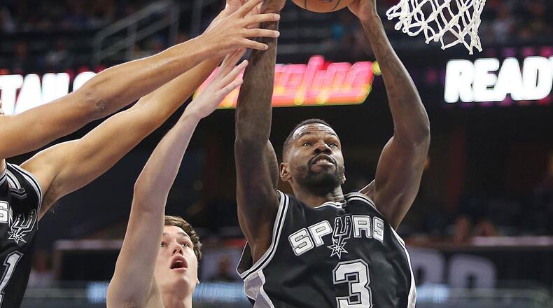 The San Antonio Spurs’ Dewayne Dedmon (3) takes the ball from the Orlando Magic’s Stephen Zimmerman (33) during a preseason game at the Amway Center in Orlando, Fla., on Wednesday, Oct. 12, 2016. The Spurs won, 95-89. (Stephen M. Dowell/Orlando Sentinel/TNS)