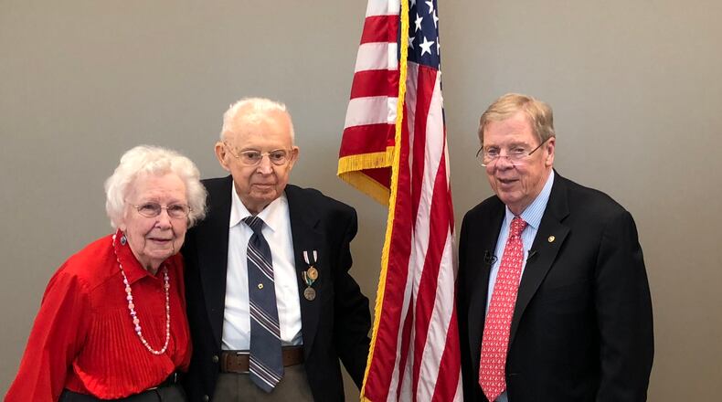 Ralph G. Rumsey (middle) was presented with a Prisoner of War Medal by U.S. Senator Johnny Isakson, on right, as his wife Ruby and other family and friends looked on.