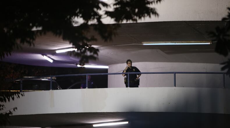 Atlanta police investigate after an officer was injured Tuesday night during a run-in with a driver who fled the Atlanta Medical Center parking deck. (BEN GRAY / BGRAY@AJC.COM)