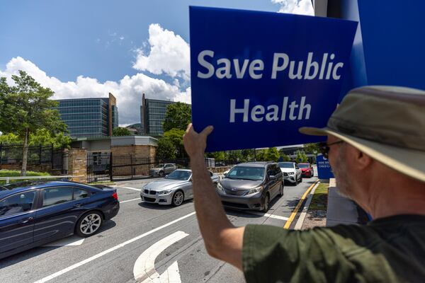 Michael Beach protests President Donald Trump's proposed cuts to health services outside the Centers for Disease Control and Prevention (CDC) headquarters in Atlanta on Tuesday, June 10, 2025. (Arvin Temkar/Atlanta Journal-Constitution via AP)
