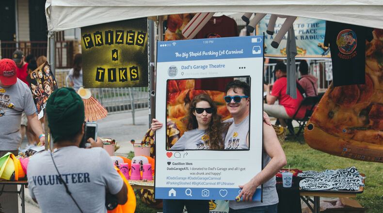 Visitors drink beer, play games, enjoy comedy booths and ride carnival rides at last year’s Big Stupid Parking Lot Carnival, a major fund-raiser for Dad’s Garage Theatre Company. This year’s carnival has been postponed due to lackluster ticket sales and concerns about the novel coronavirus. CONTRIBUTED: DAD’S GARAGE THEATRE