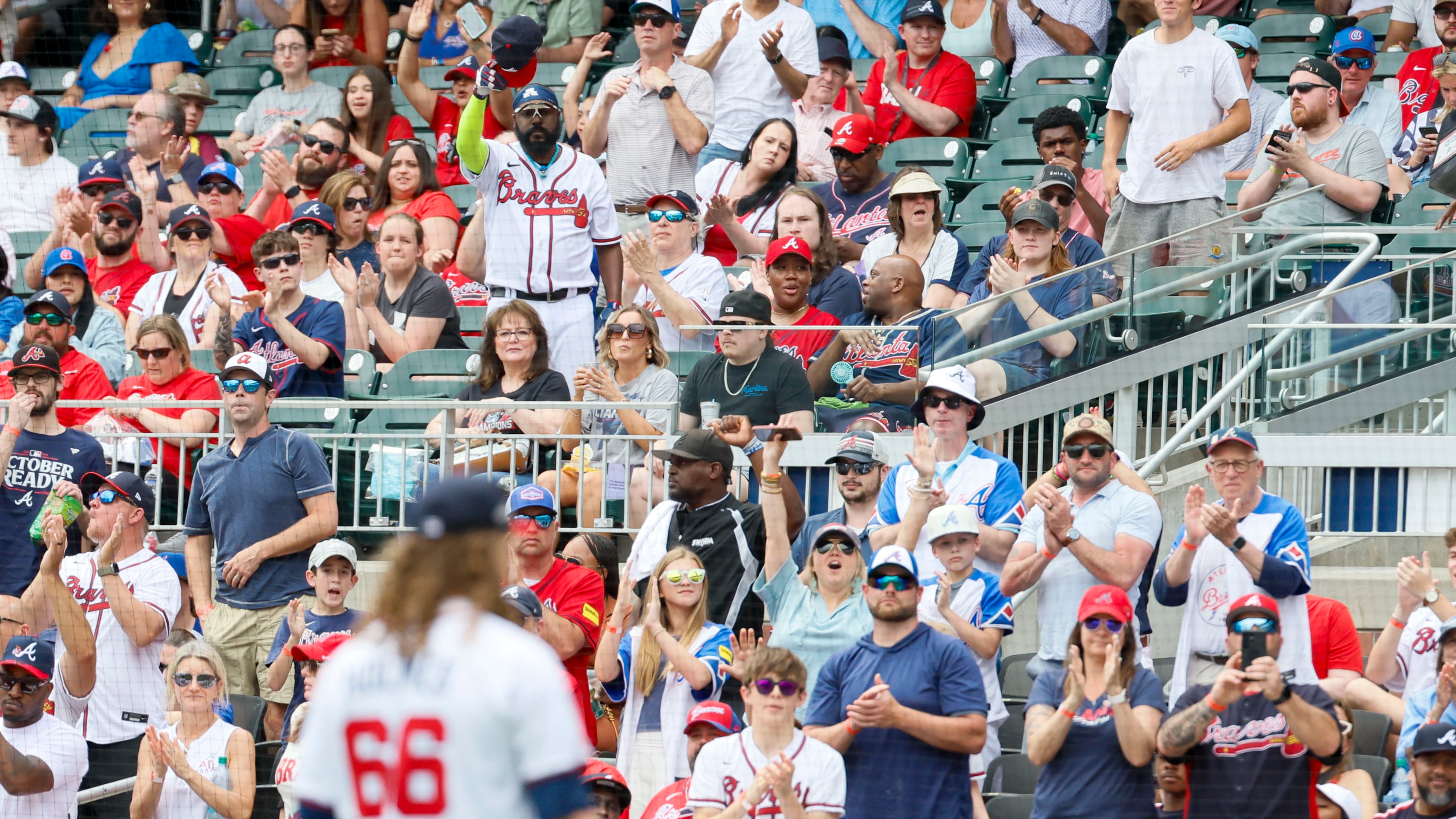 Braves fans cheer on Braves starting pitcher Grant Holmes as he walks to the dugout after being removed from the mound by Atlanta Braves manager Brian Snitker during the sixth inning against the Minnesota Twins at Truist Park on Sunday, April 20, 2025, in Atlanta. (Miguel Martinez/AJC)