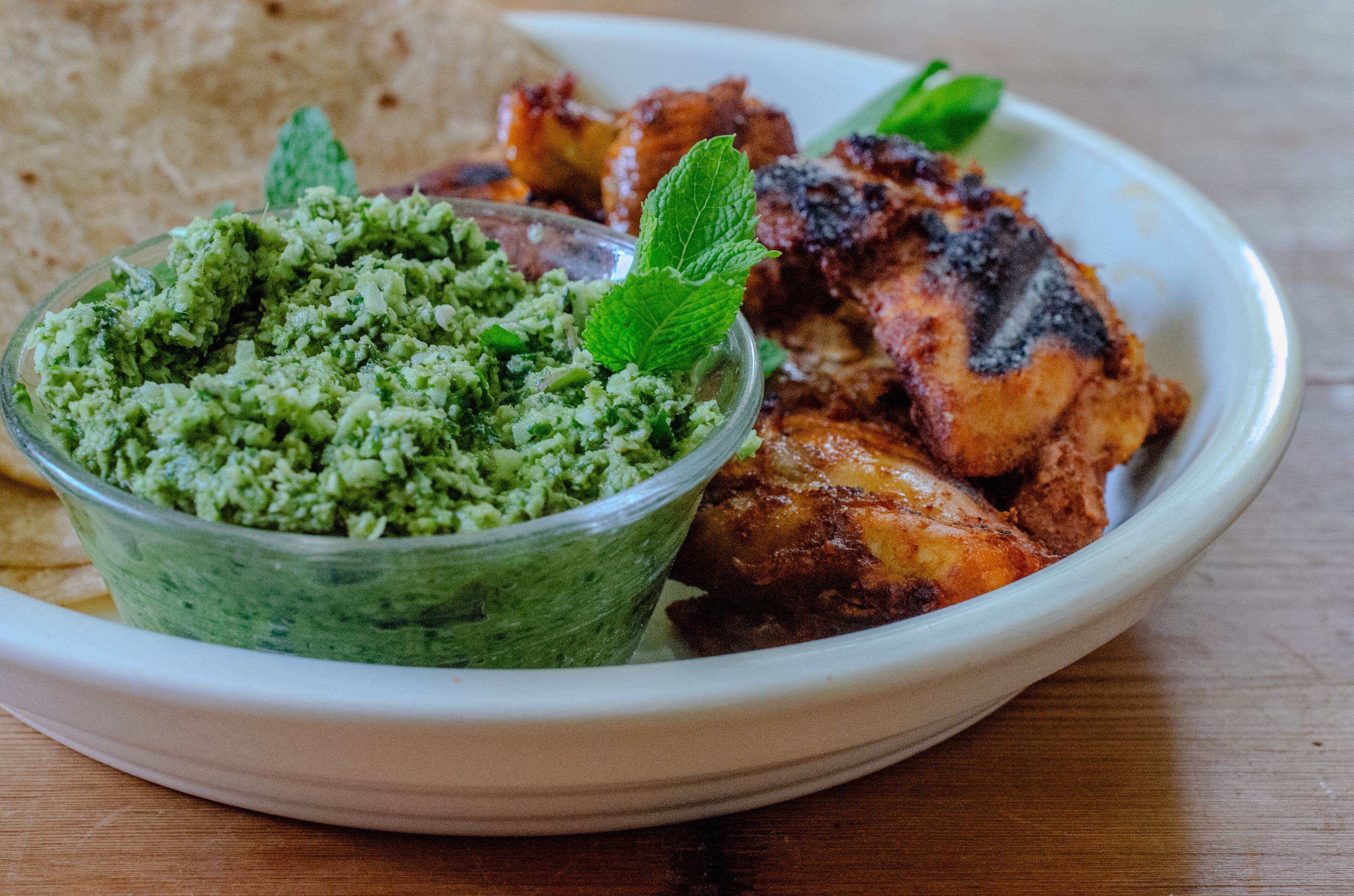 Indian Green Chutney with Tandoori Chicken combines tropical flavors in a crave-worthy herb salsa, perfect for grilled meats. (Virginia Willis for the AJC)