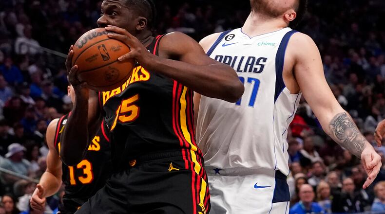 Atlanta Hawks center Clint Capela (15) gets past Dallas Mavericks guard Luka Doncic (77) on the way to the basket during the second half of an NBA basketball game in Dallas, Wednesday, Jan. 18, 2023. Hawks won 130-122. (AP Photo/LM Otero)