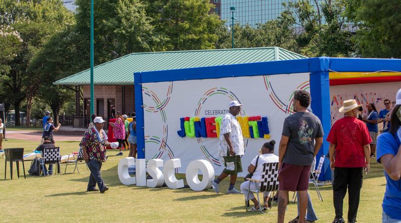People observe and walk through Cisco’s stand at the Juneteenth Parade and Music Festival in Atlanta on Saturday, June 17, 2023. (Katelyn Myrick/katelyn.myrick@ajc.com)