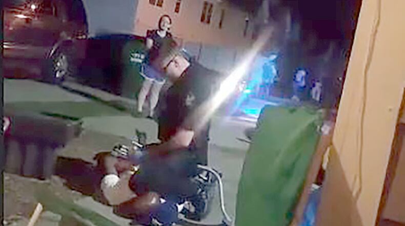 A screengrab from a video posted on Facebook shows a man being arrested by a Monroe police officer Saturday night.