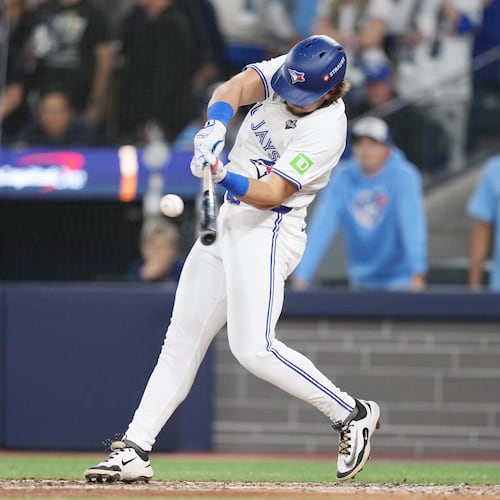 Toronto Blue Jays' Addison Barger hits a grand slam against the Los Angeles Dodgers during the sixth inning in Game 1 of baseball's World Series, Friday, Oct. 24, 2025, in Toronto. (Nathan Denette/The Canadian Press via AP)