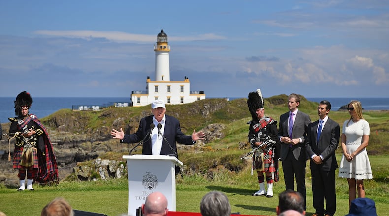 Presumptive Republican nominee for US president Donald Trump gives press conference on the ninth tee at his Trump Turnberry Resort surrounded by his family Eric Trump, Donald Trump Jr. and Ivanka Trump on Friday in Ayr, Scotland. Jeff J Mitchell/Getty Images
