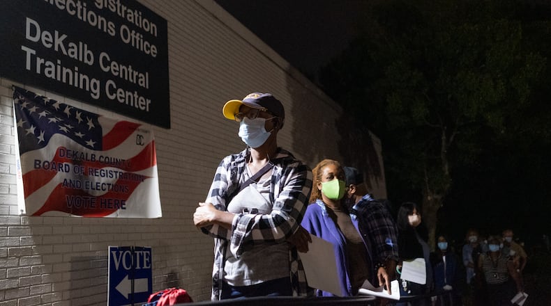 201012-Decatur-Sharon Buie, of Decatur, waits near the front of the early voting line just before it opened at 7AM Monday morning October 12, 2020 at the DeKalb County elections office in Decatur. Buie arrieved at 5:30AM and was fifth in line. When asked why she arrived so early on the first day of early voting, she replied, “John Lewis!”  Ben Gray for the Atlanta Journal-Constitution