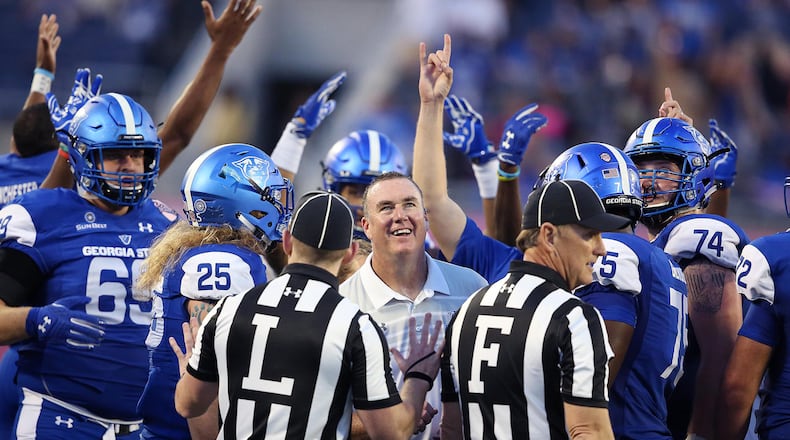 Georgia State head coach Sean Elliott and players celebrate as they watch a replay on the stadium television screen during the Cure Bowl against Western Kentucky at Camping World Stadium in Orlando, Fla., on Saturday, Dec. 16, 2017. Georgia State won, 27-17. (Stephen M. Dowell/Orlando Sentinel/TNS)