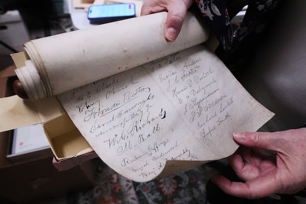 Rev. Diane Badger unfurls a recently found, 178-year-old anti-slavery scroll at Grotonwood, the home mission of The American Baptist Churches of Massachusetts, Thursday, June 26, 2025, in Groton, Mass. (AP Photo/Charles Krupa)
