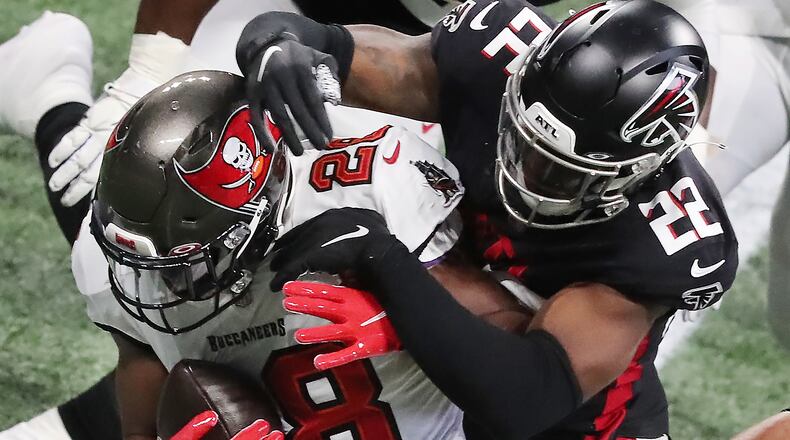 Falcons safety Keanu Neal tackles Buccaneers running back Leonard Fournette during the first quarter Sunday, Dec. 20, 2020, at Mercedes-Benz Stadium in Atlanta. (Curtis Compton / Curtis.Compton@ajc.com)