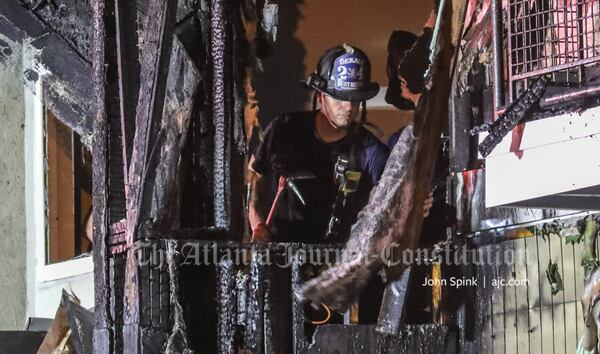 Flames had reached the top floor of the three-story apartment building by the time DeKalb County fire crews arrived.