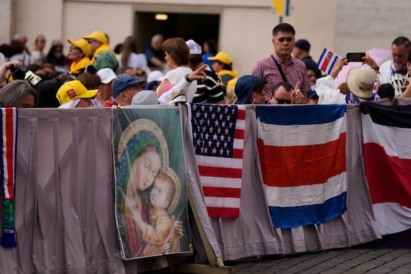 Faithful wait for Pope Leo XIV weekly general audience in St. Peter's Square at The Vatican, Wednesday, May 21, 2025. (AP Photo/Gregorio Borgia)