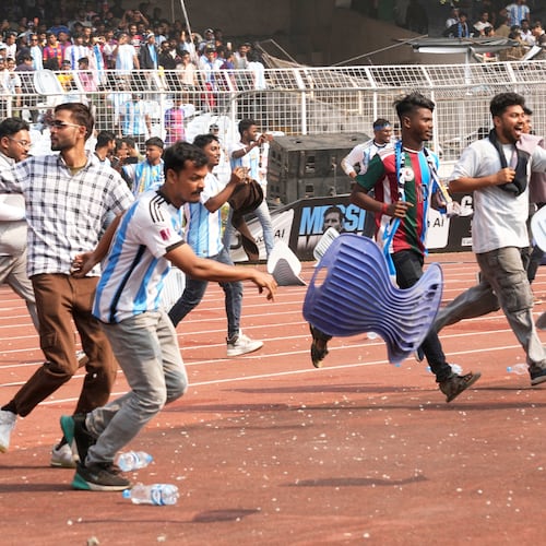 Indian fans vandalize stadium chairs as they run on to the field after failing to get a glimpse of Argentine soccer star Lionel Messi at the Salt Lake Stadium, in Kolkata, India, Saturday, Dec. 13, 2025. (AP Photo/Bikas Das)