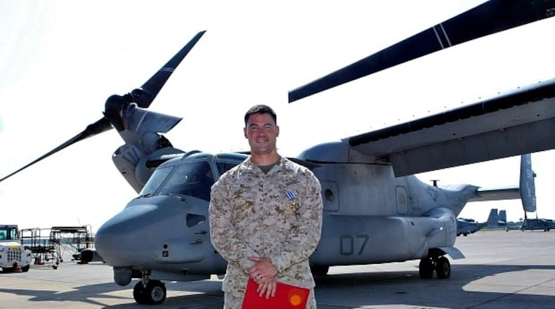 Capt. David Haake stands in front of an Osprey, a hybrid vehicle that can take off and land like a helicopter but also fly like a plane, that he flew on missions in Afghanistan.