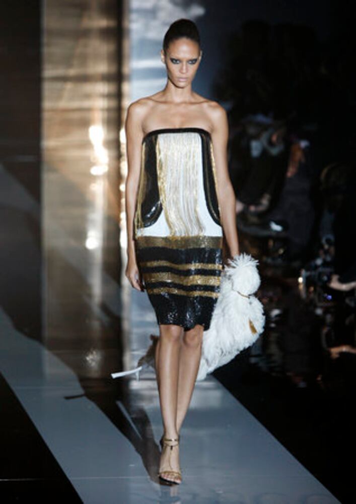 Models take the catwalk during Milan Fashion Week 2011