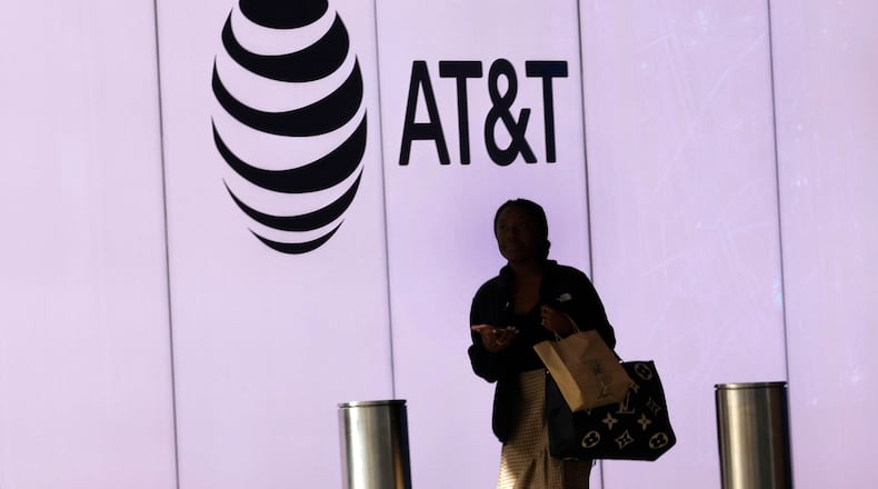 A woman walks by an AT&T logo at AT&T Discovery District in downtown Dallas,Thursday, Feb. 22, 2024, in Dallas. (Chitose Suzuki/The Dallas Morning News/TNS)