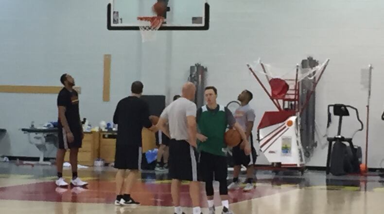 Josh Magette (right) talks with assistant coach Neven Spahija after Hawks practice Monday. Photo by Chris Vivlamore